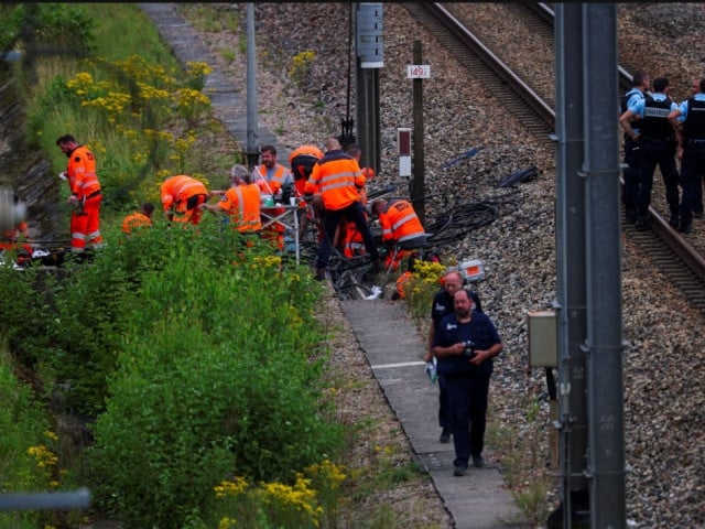rail workers and police at a site targeted by arsonists photo reuters